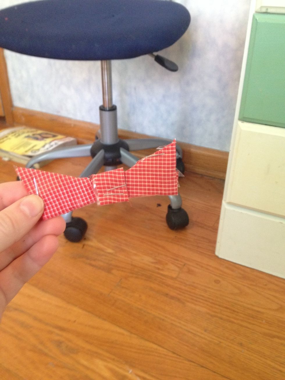 Staple the two pointed edges into the hole in the first red shape.