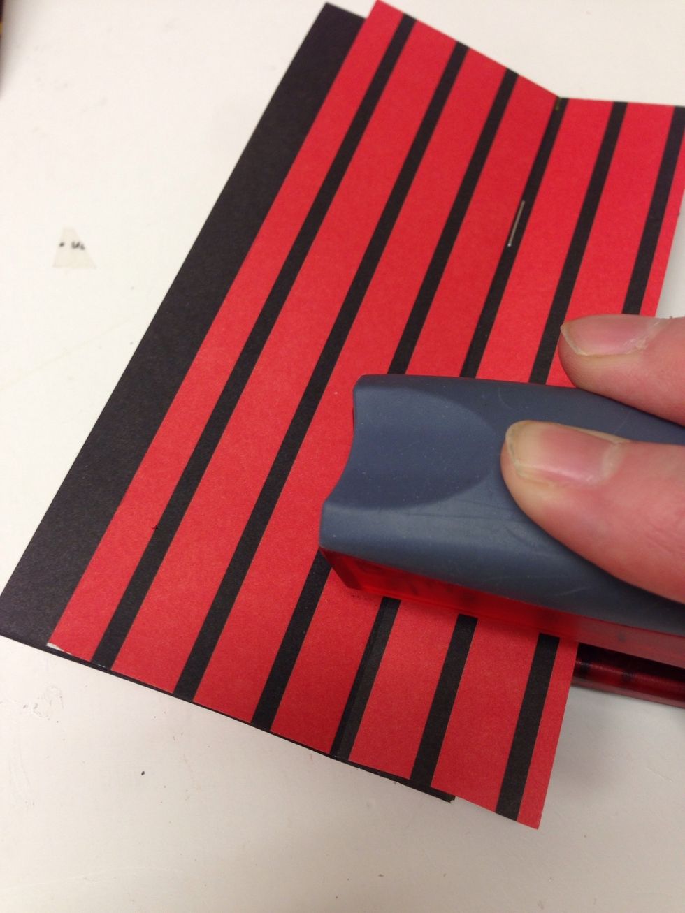 Staple together along the crease to form the spine of your album.