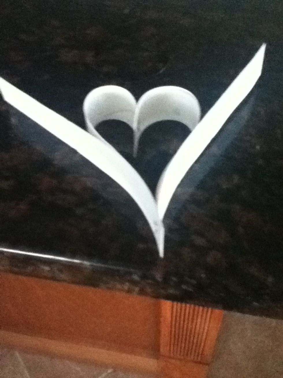 Staple two nor strips of paper to the bottom of the heart. Again if you have a design have it face inwards