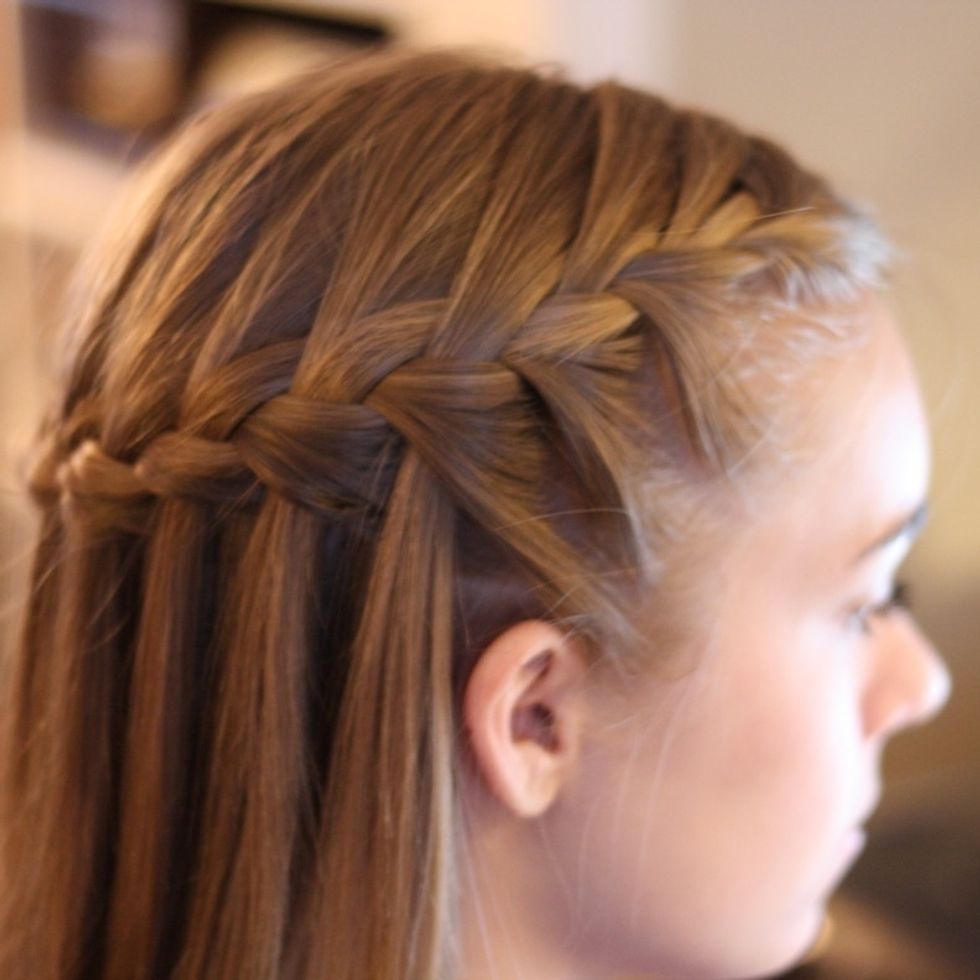 Start a French braid on one side of the head. When your braid gets past the ear, only braid in half of the bottom section of braid, letting the other half of that section fall back down.