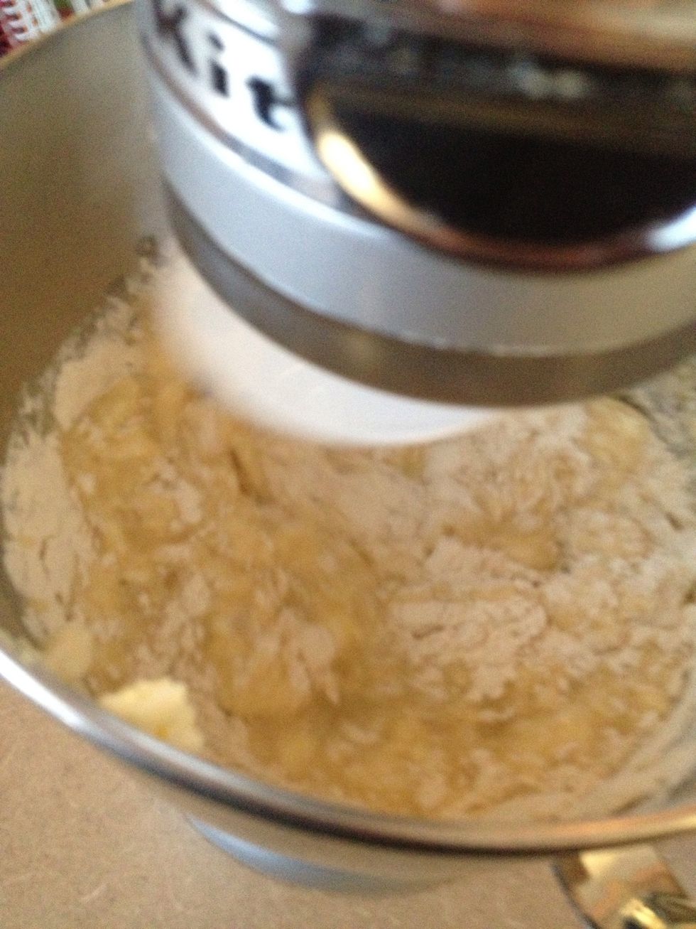 Start adding flour, 2 cups at a time to bowl