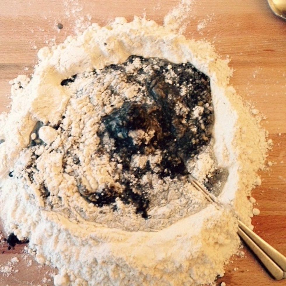 Start adding the ink and keep mixing it with the flour