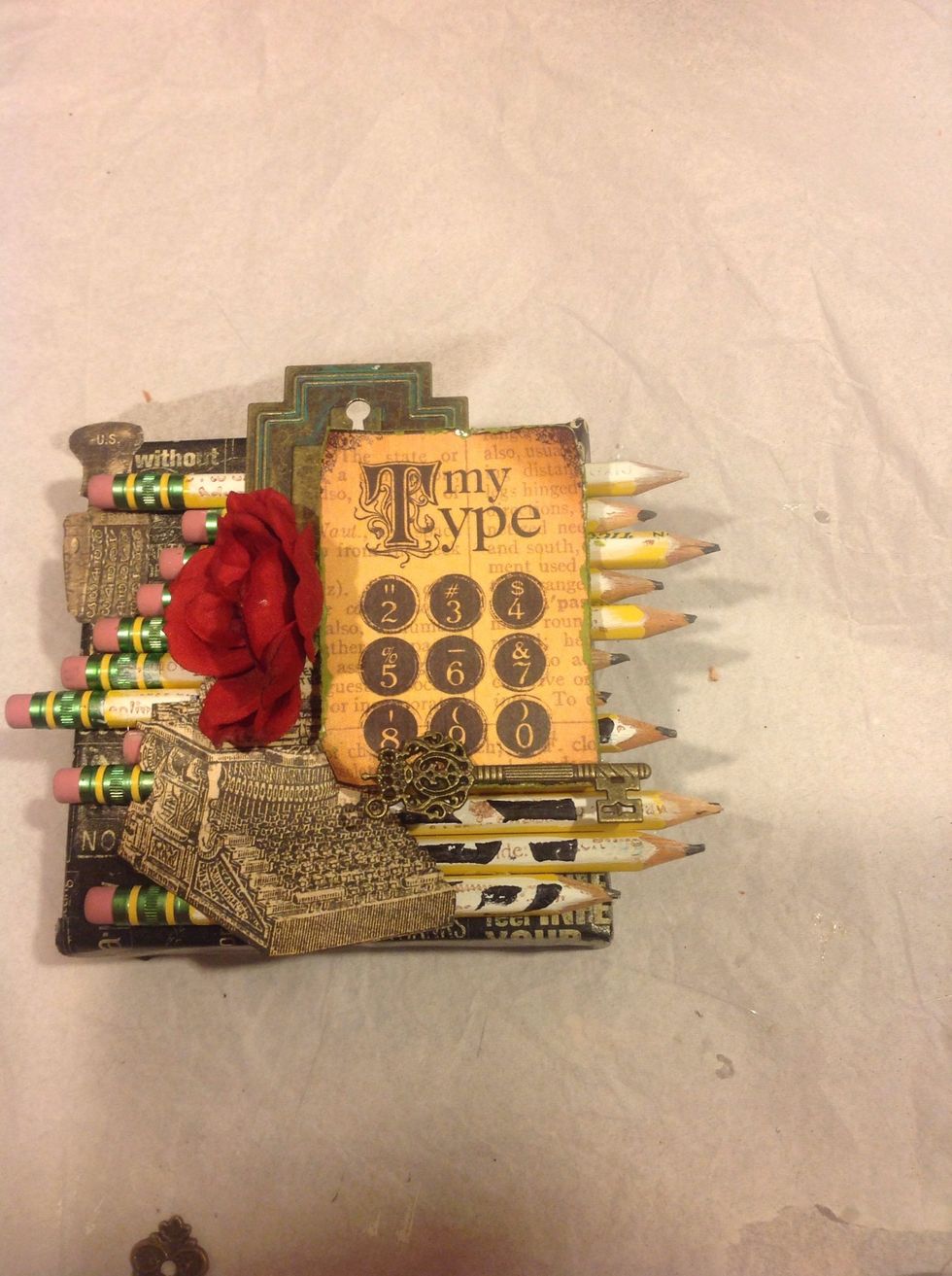 Start adhering down your embellishments. Add as much or as little as you like.