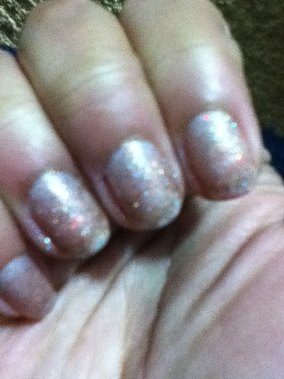 Start applying base coat on your nails then add two coats of a glitter nail polish