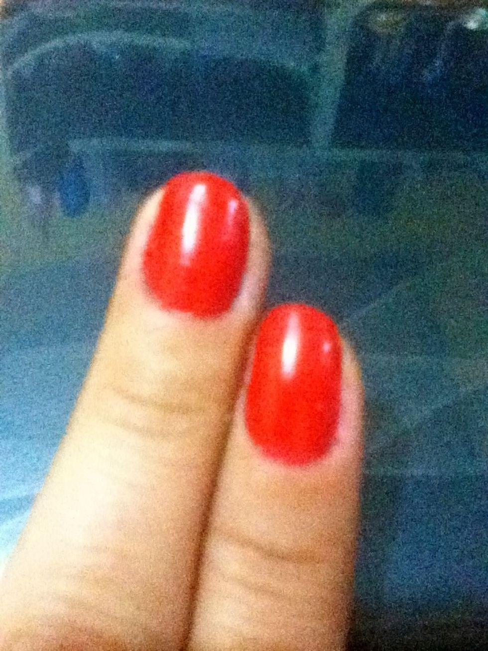 Start applying your base coat then paint all of your nails red