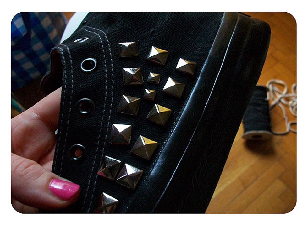 Start arranging your studs on the side of the shoe, pushing in and using the pliers to close the ends on the inside