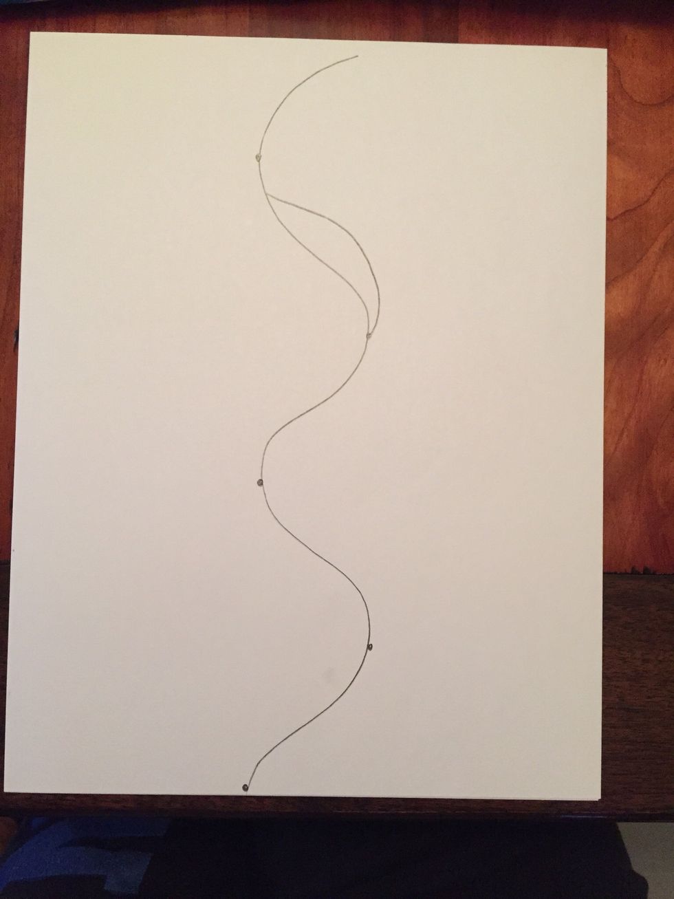 Start at one dot on the right side by drawing a line from the dot in the direction of your wavy line. Connect line to your first wavy line.
