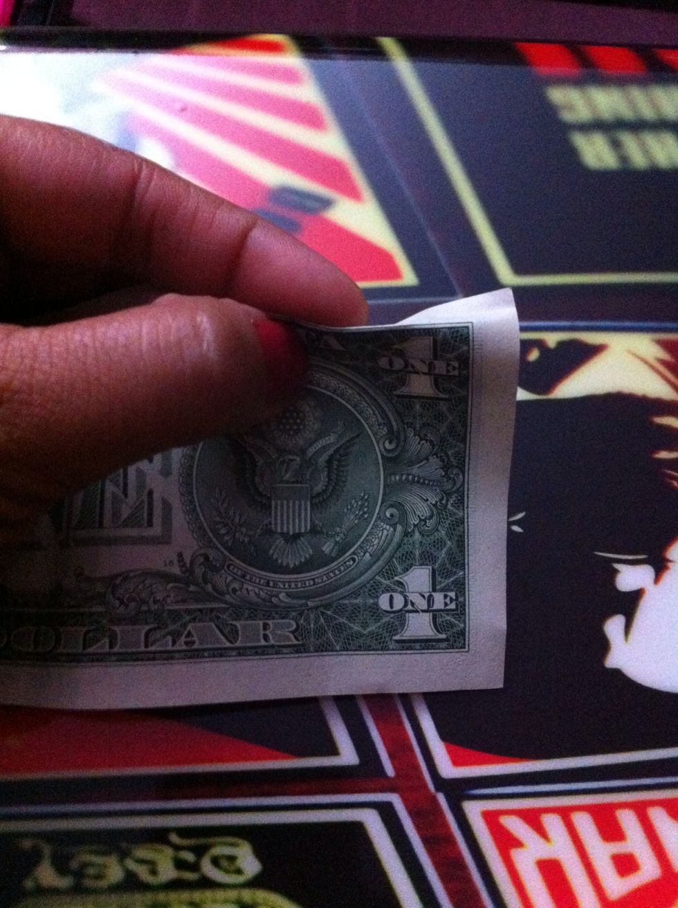 Start at the back of the bill and fold down all the way across the top between the green and white line.