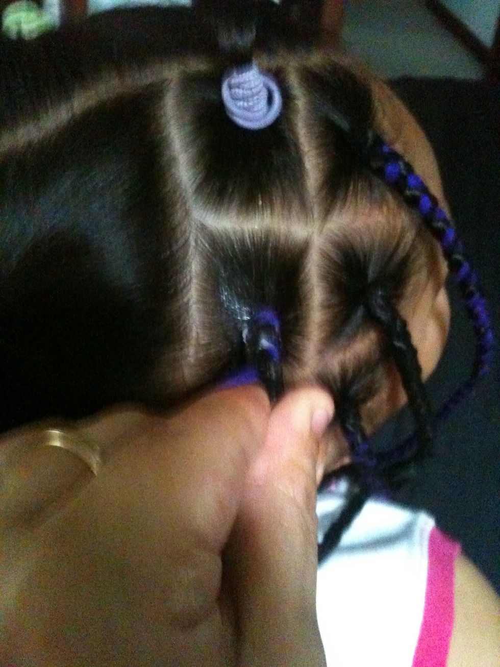 Start braiding the hair like normal using each color as a strand in the braid and the hair as your third strand