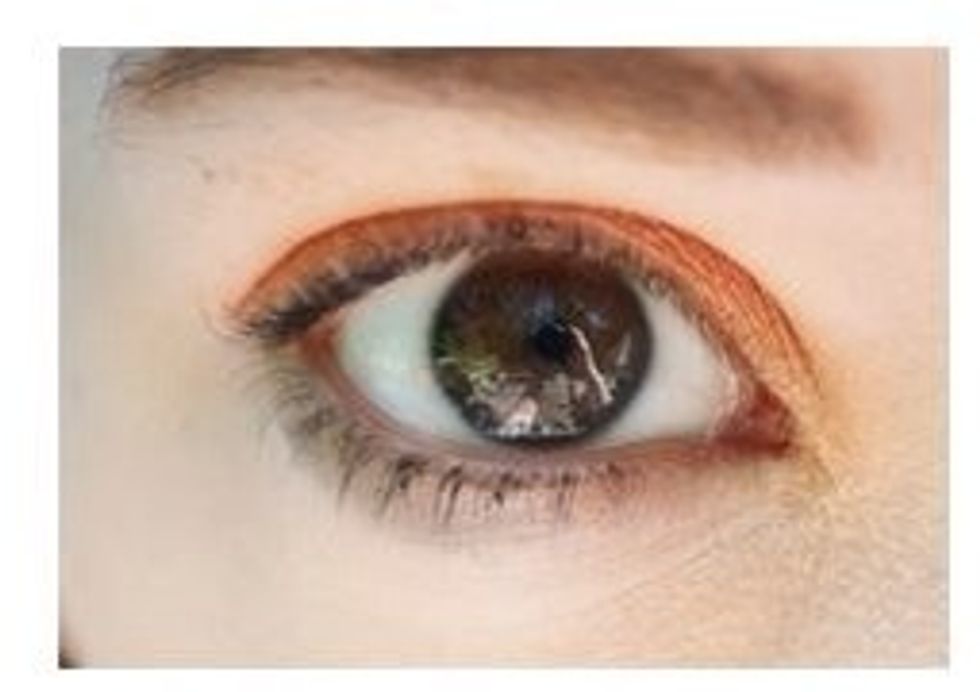 Start by adding an orange eyeshadow all over the lid.