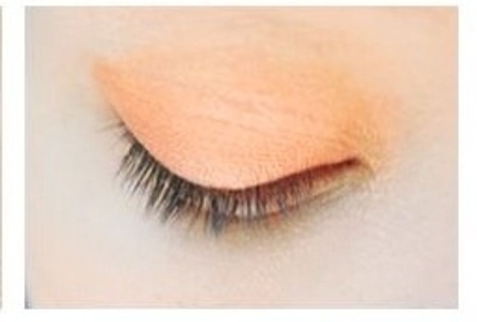 Start by adding an orange eyeshadow all over the lid.