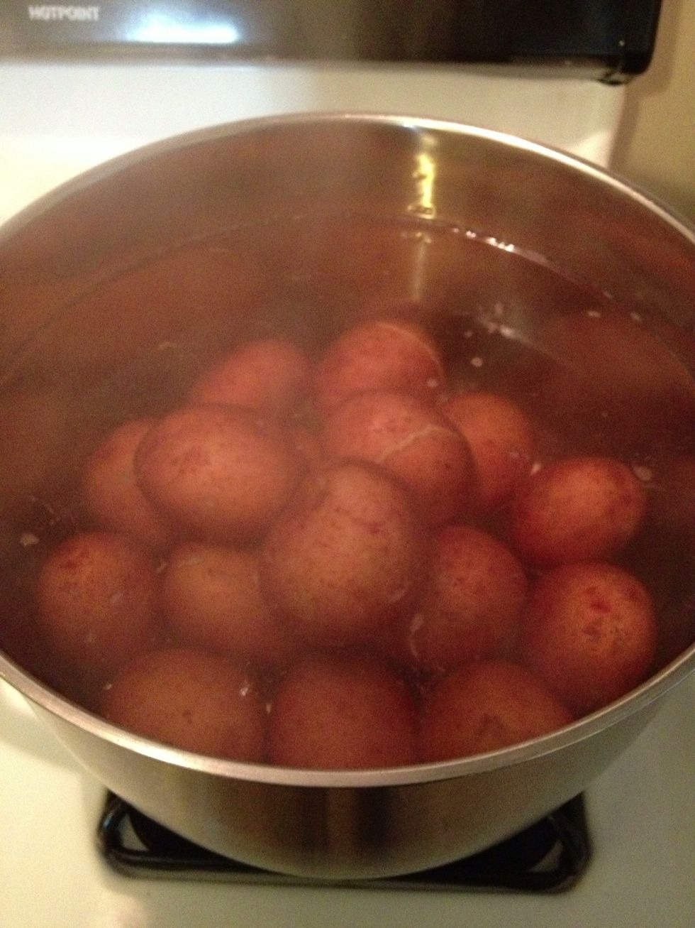 Start by boiling the potatoes. Add potatoes to cold water first and then turn on high heat.