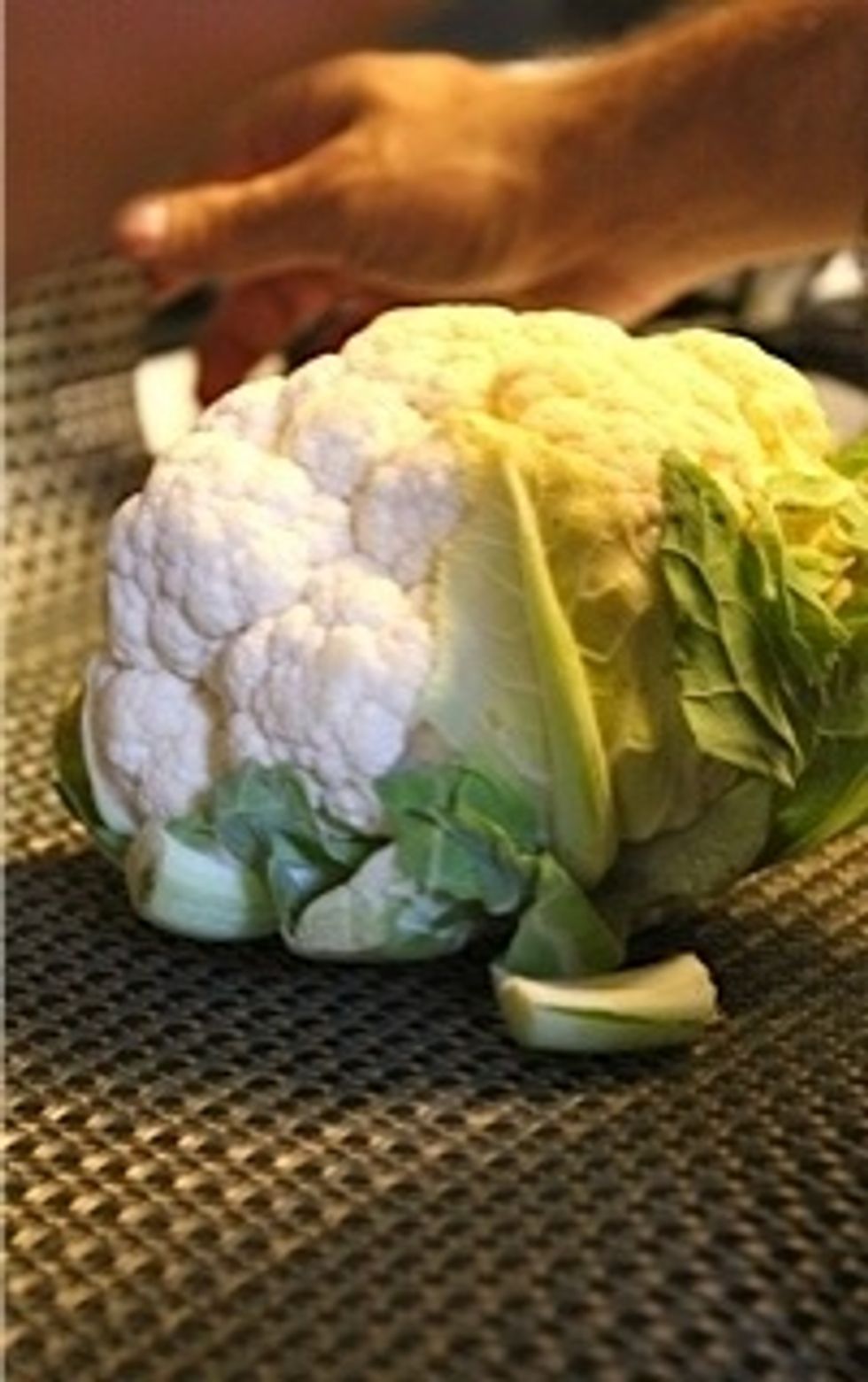 Start by boiling water in pot. Wash cauliflower.