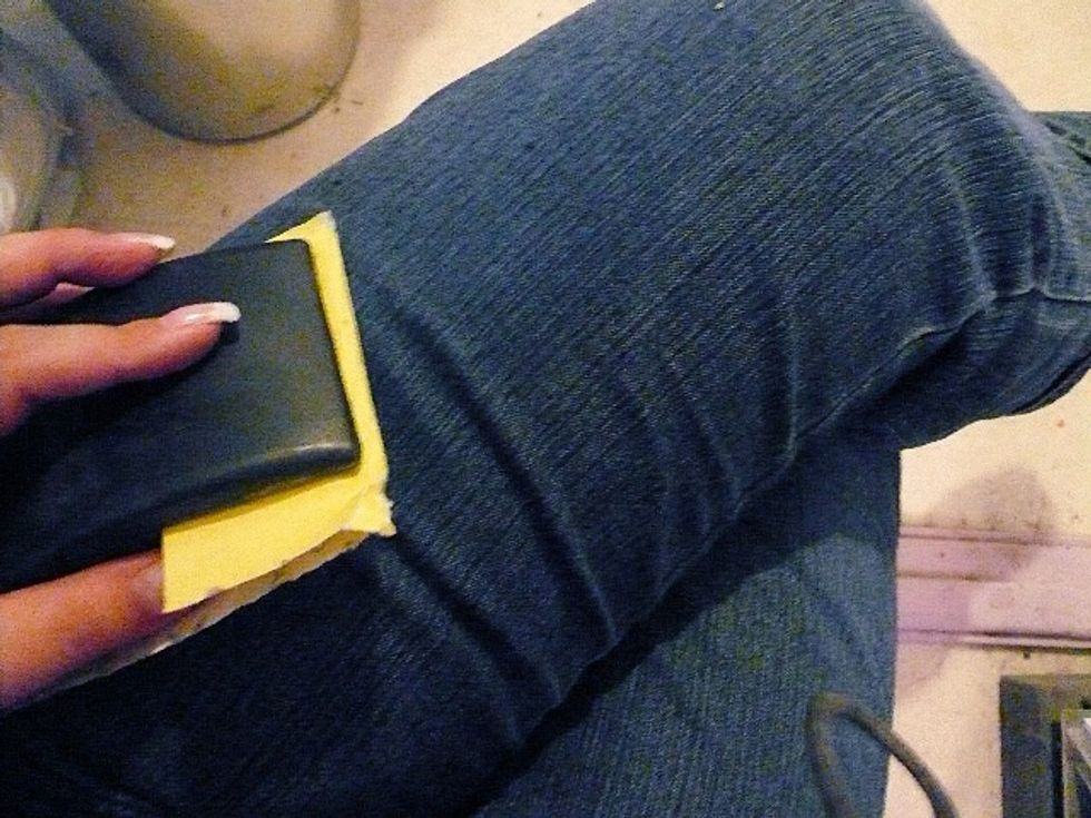 start by brushing the jeans with sandpaper where you want them to look worn. i did this while wearing them to get the effect in the right places.