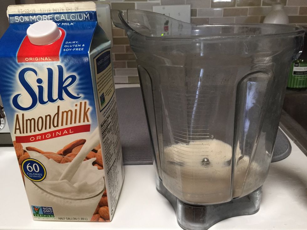 Start by covering the blade of your blender with about a half cup of almond milk.