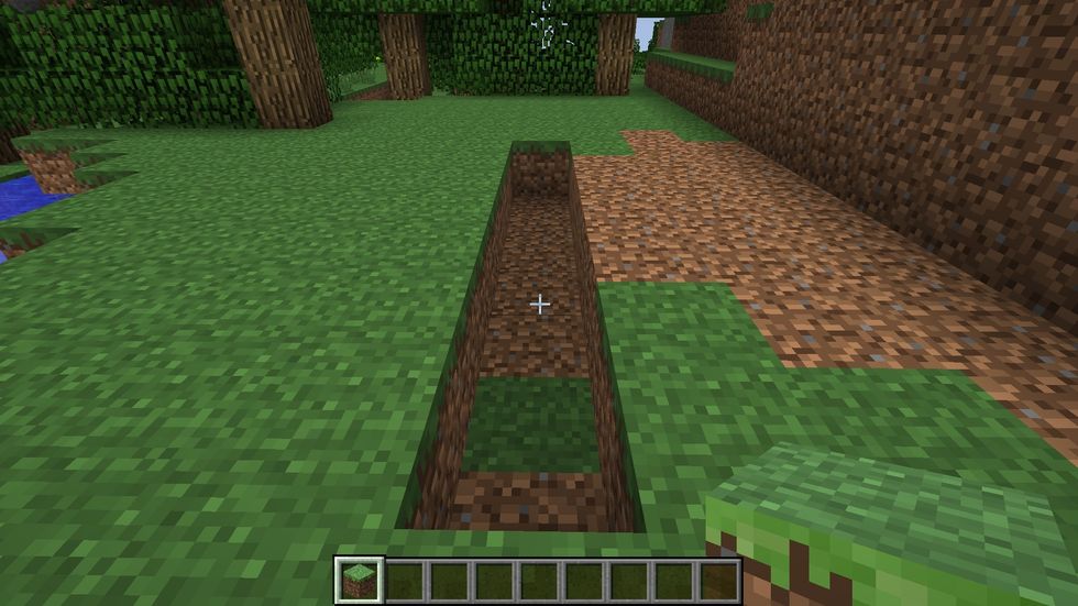Start by creating an aqueduct so that the water in the divot will touch the sugar cane on each side. I made mine 7 blocks long.