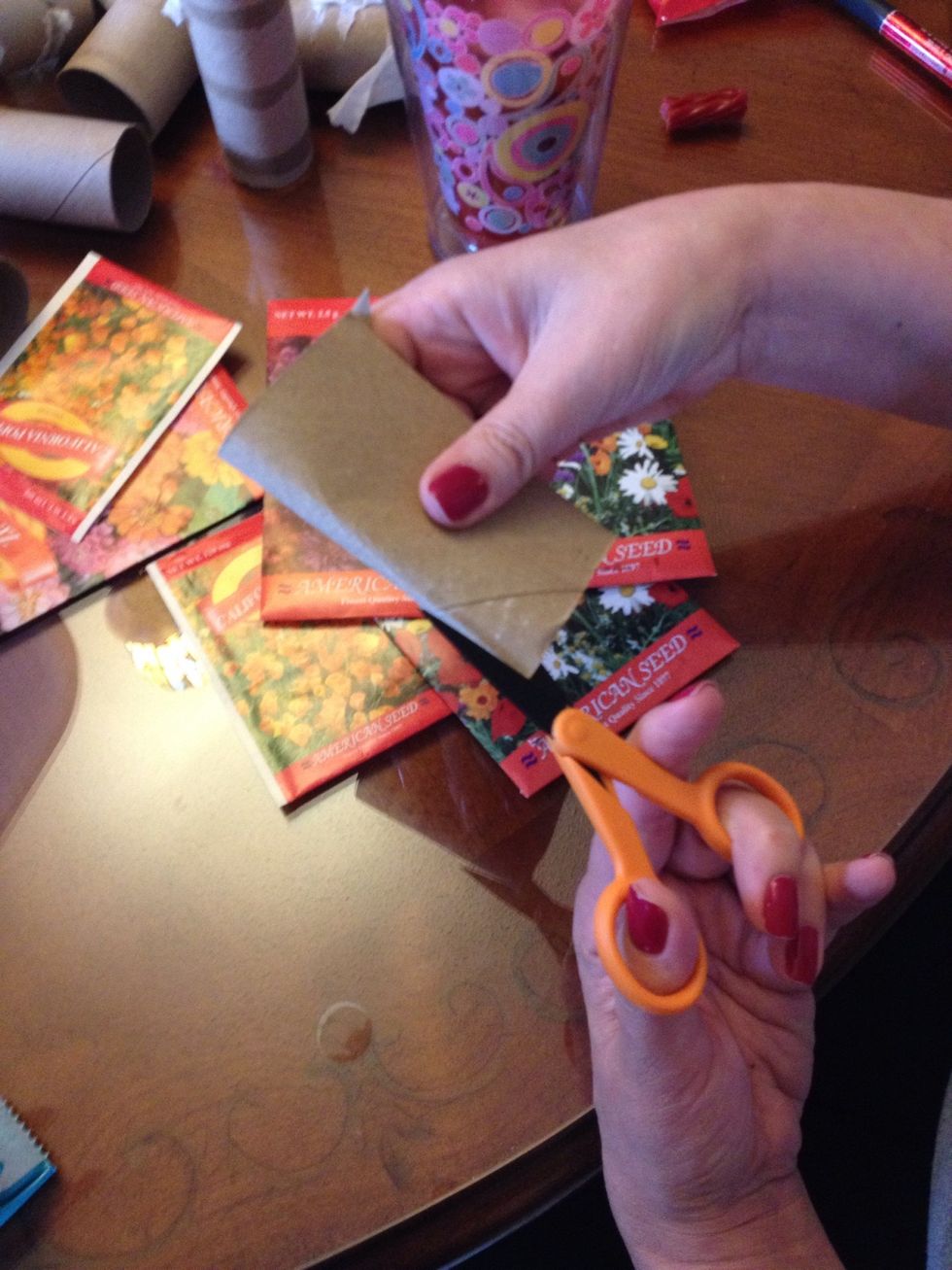 Start by cutting 4 1-inch slits in one end of the roll, evenly apart. I do this by flattening and cutting the first two 1-inch strips in the two sides.