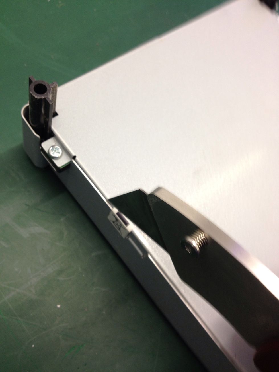 Start by cutting along the seam through the warranty void label.