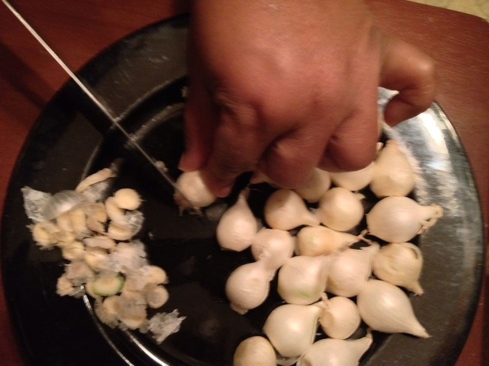 Start by cutting off the root end,  but don't cut too much, just nip it off.  ** the root end is the flat end just like any other onion.