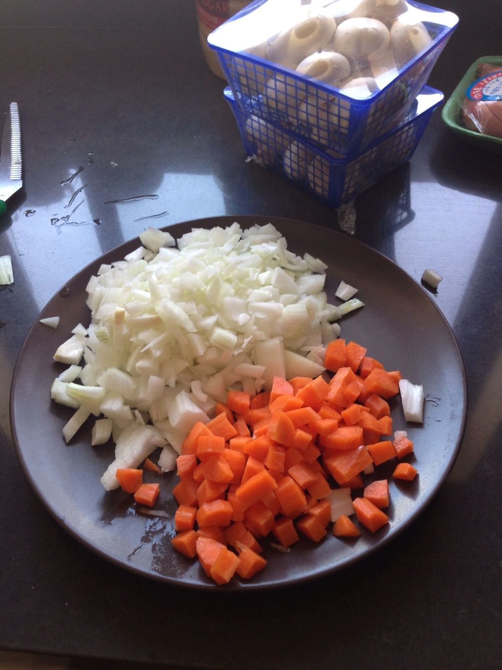 Start by dicing up the carrot and onion.