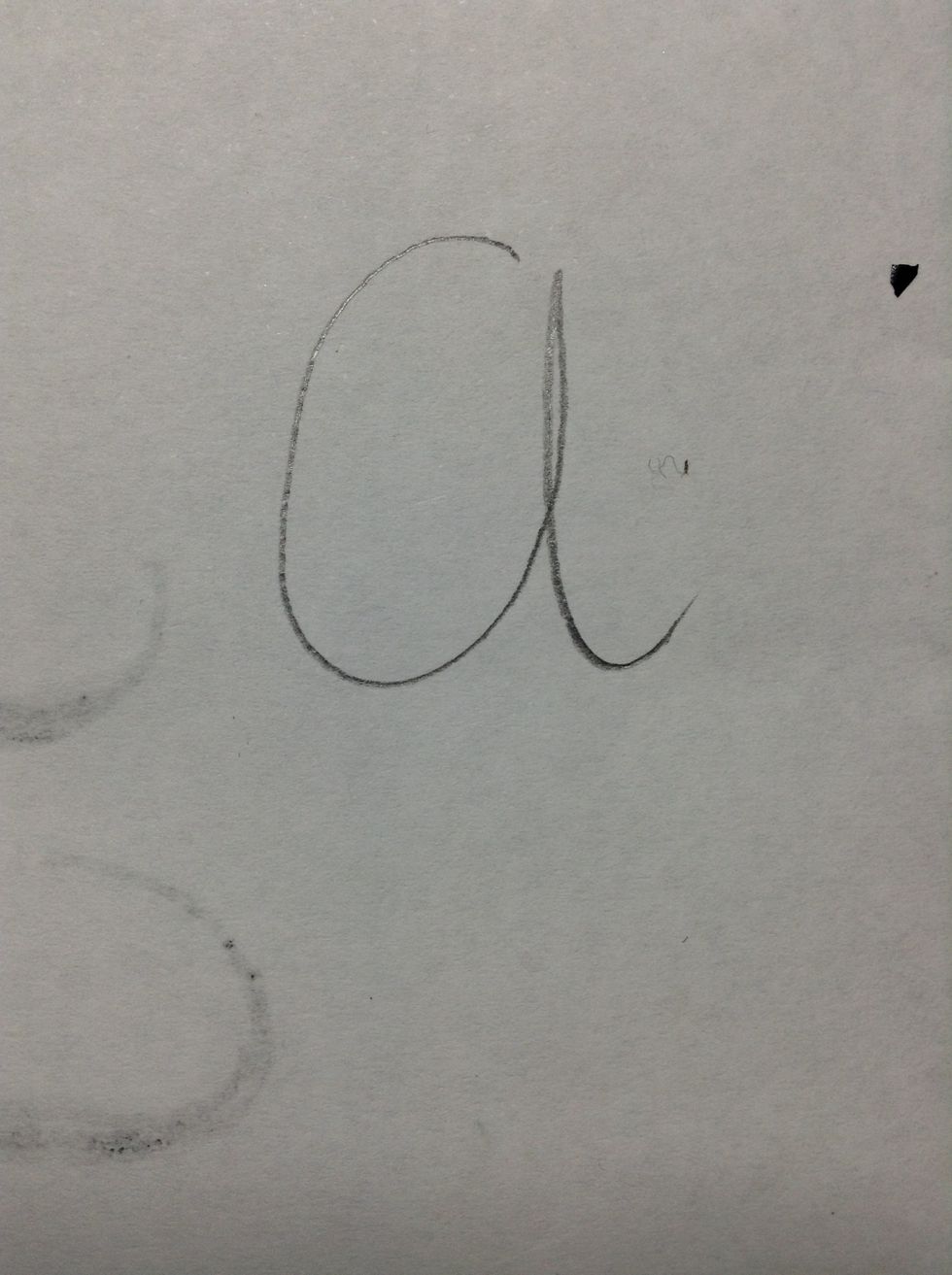 Start by drawing a cursive letter in your own handwriting style. Nothing fancy.