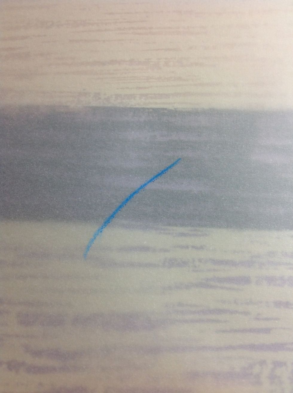 Start by drawing a curved line, stroke from the top. I am drawing on tracing paper.