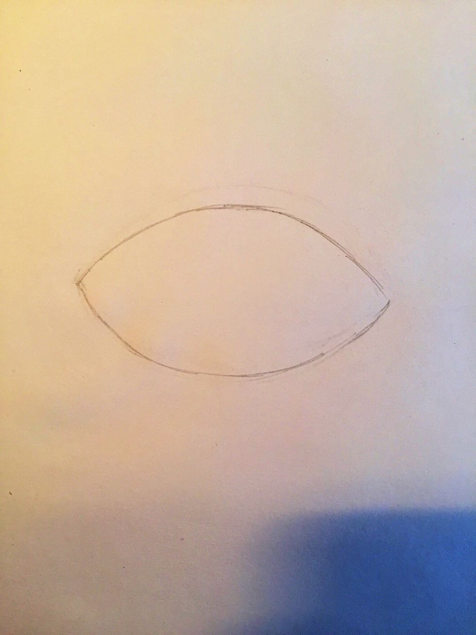 Start by drawing a football-like shape. This is the outline of the eye.