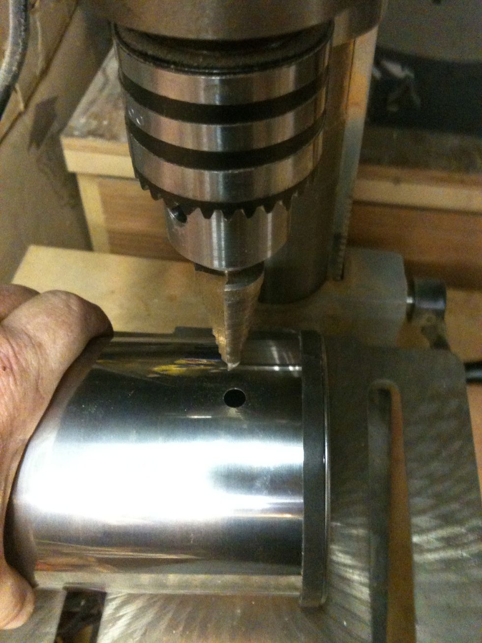 Start by drilling a 1/2" hole near the top of the canister. Then on the oppostie side drill a 3/8" hole.