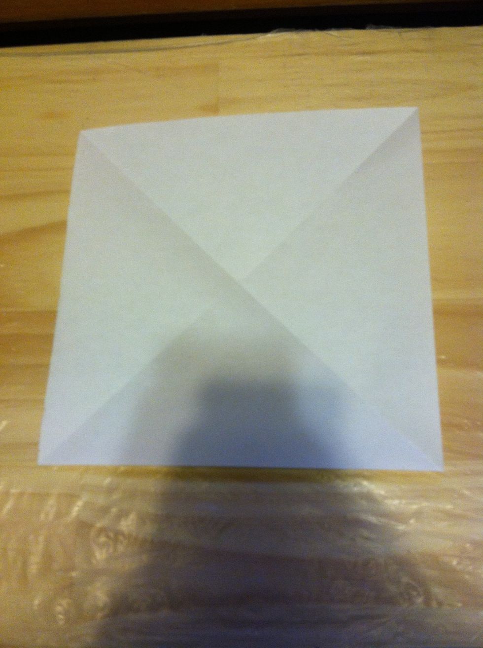 Start by folding the paper in half on both diagonals.