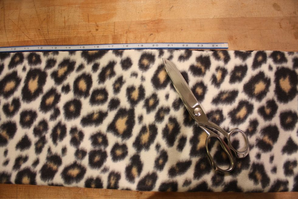 Start by folding your 1/2 yard longwise with the right sides together. Cut 22-24 inches depending on head size. My head was 21 inches-so I cut 24. You should be able to make 2 neckwarmers