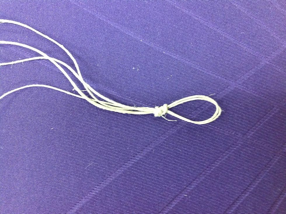 Start by folding your hemp in half (equal lengths on both sides) and tying a knot at the top (should have four separate strings now), leaving a loop at the top.