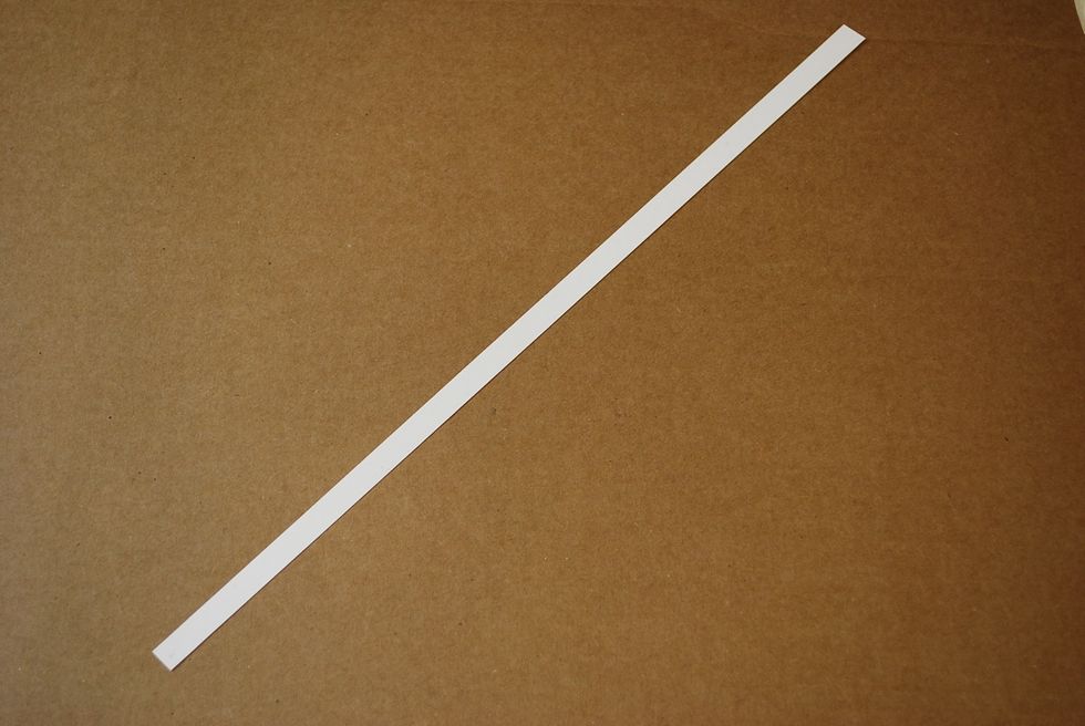 Start by laying out the white strip, diagonally