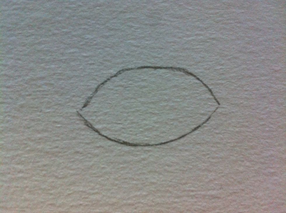 Start by lightly sketching an oval or "football" shape. You'll build on your eye from here.