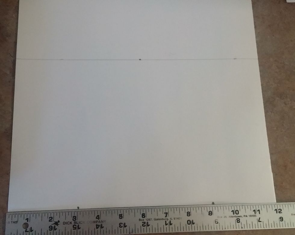 Start by making a line horizontally across the paper at about 5 inches. Place a dot on this line 6 inches in. This is the middle of the line and will be referred to as the Vanishing Point.