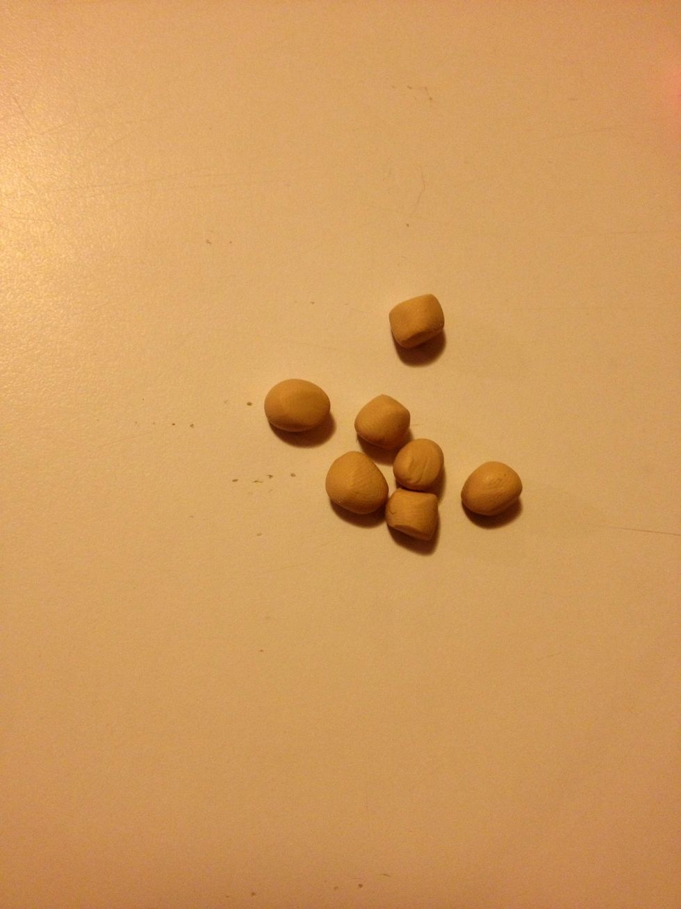 Start by making small balls of tan clay.