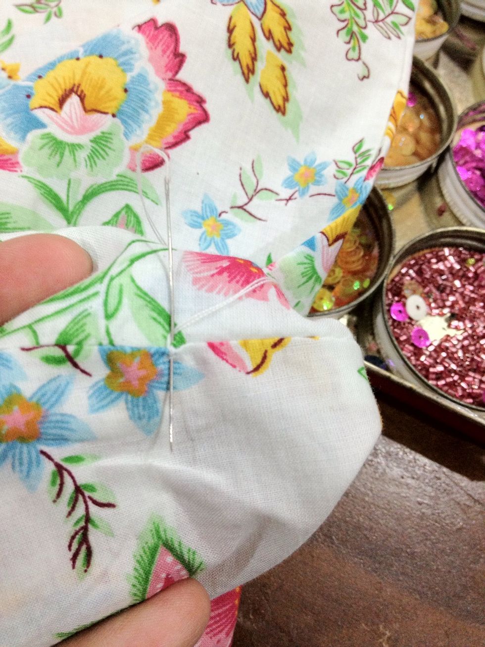 Start by making small knot by sewing at the same spot for few times.