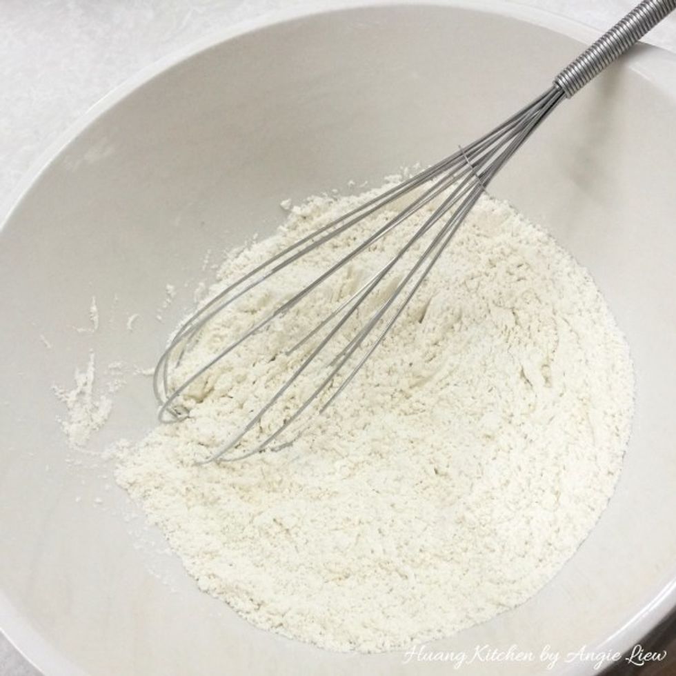 Start by making the butter pastry. Place the flour, salt and sugar in a large bowl. Whisk everything till well combined.