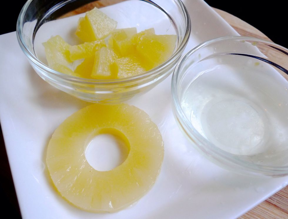 Start by making the sweet and sour sauce. Drain juice from canned pineapple. Cut pineapple rings into thick slices. Set the pineapple slices aside for later use.