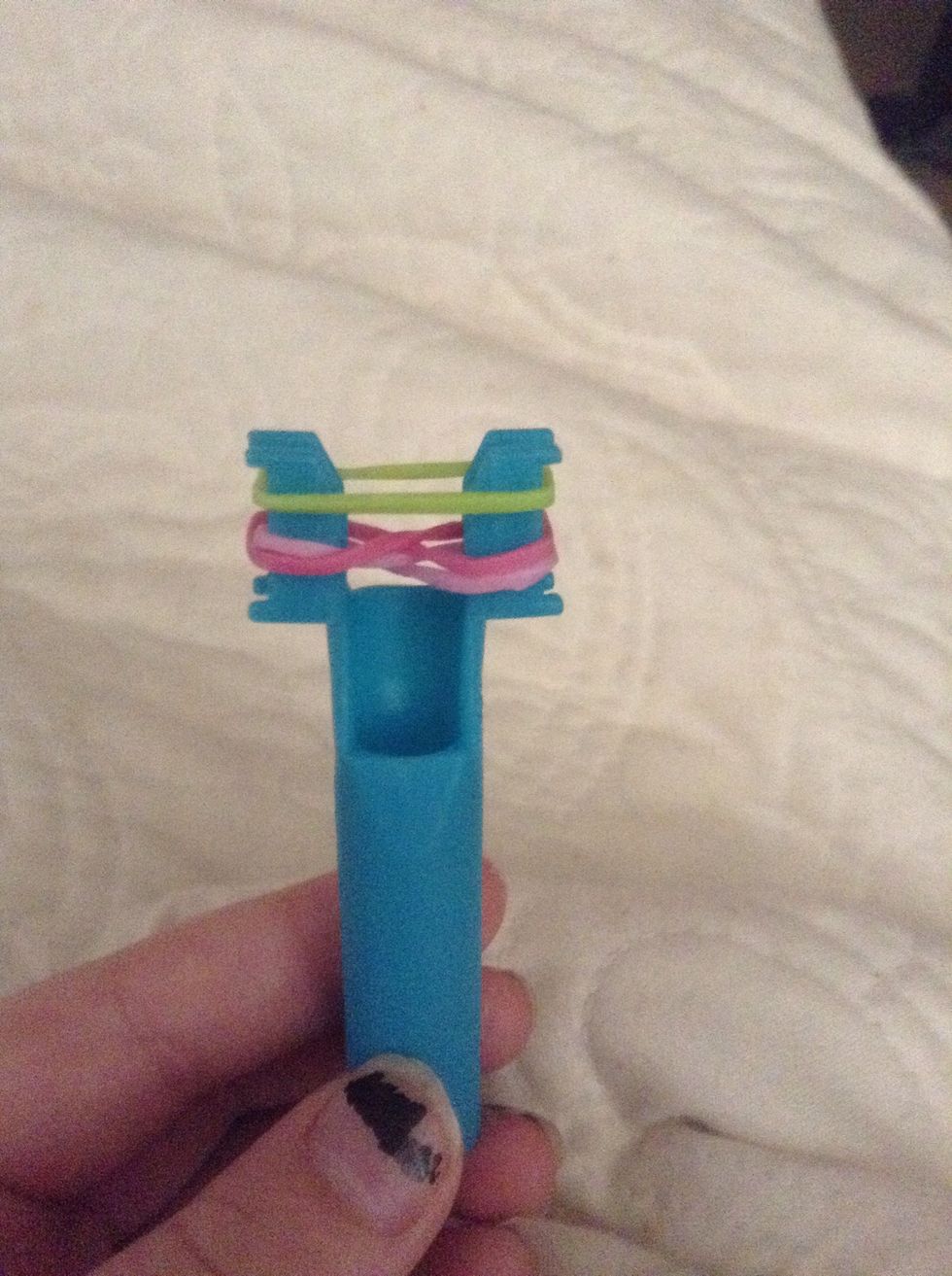 Start by making two infintys (this is the Rose) and stretch and green band over top.