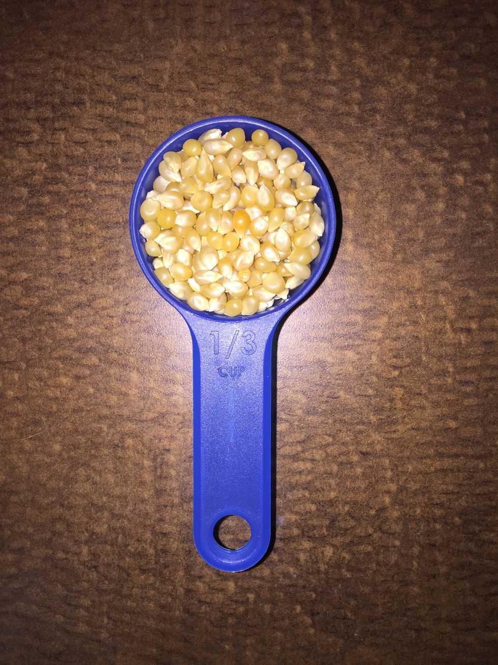 Start by measuring out no more than 1/3 cup of popcorn kernels