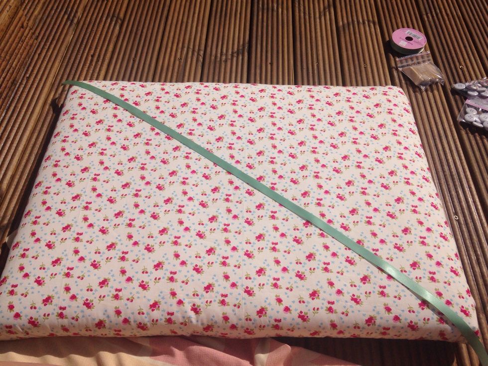 Start by measuring the centre ribbon diagonally across the bulletin board.