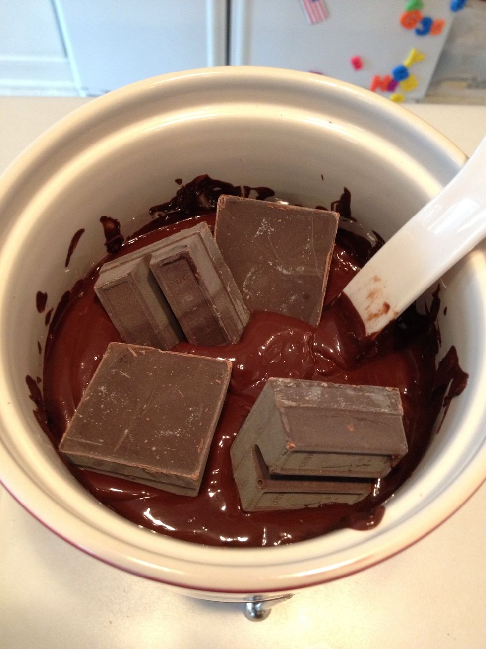 Start by melting the chocolate. You could use a double boiler or a fondue pot like I did. Melt 4 squares, stir, then add 4 more until all the chocolate is melted.
