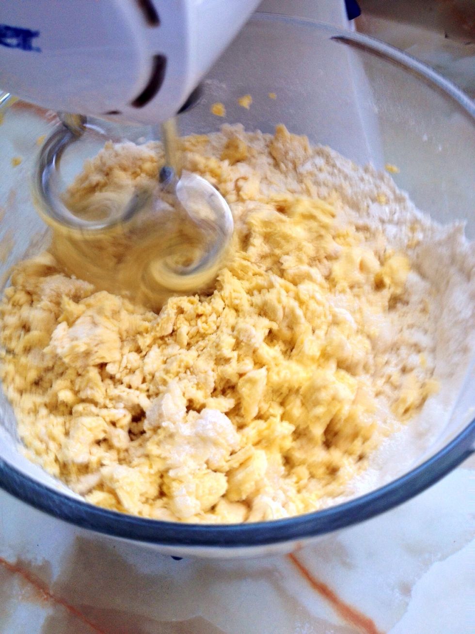 Start by mixing the flour (with a teaspoon of baking powder and salt), sugar and butter on high