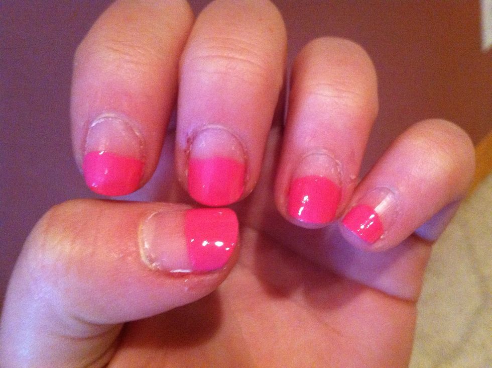 Start by painting half of your nails pink