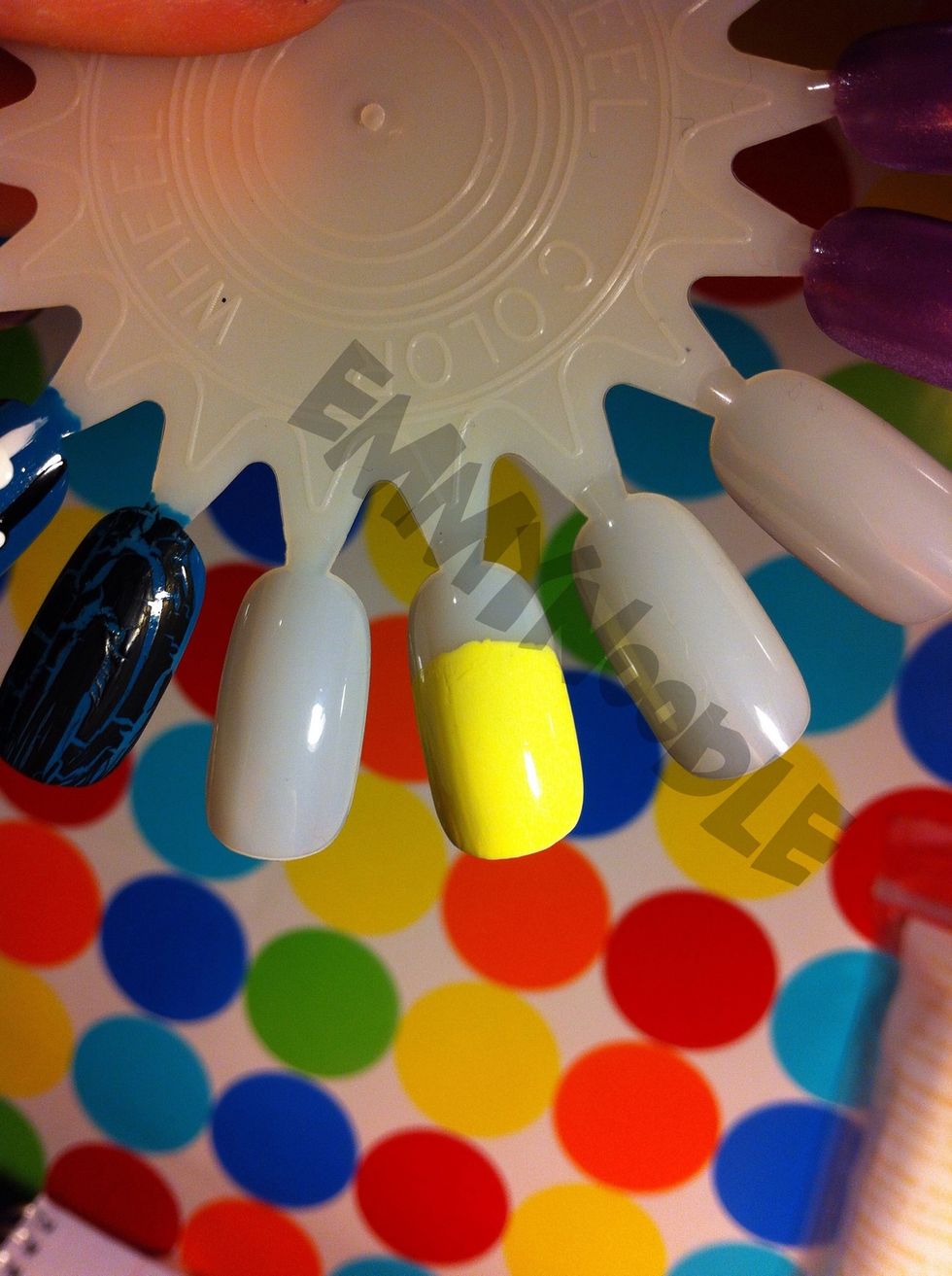 Start by painting most of your nail a soft yellow, leaving a small space at the top of your nail.