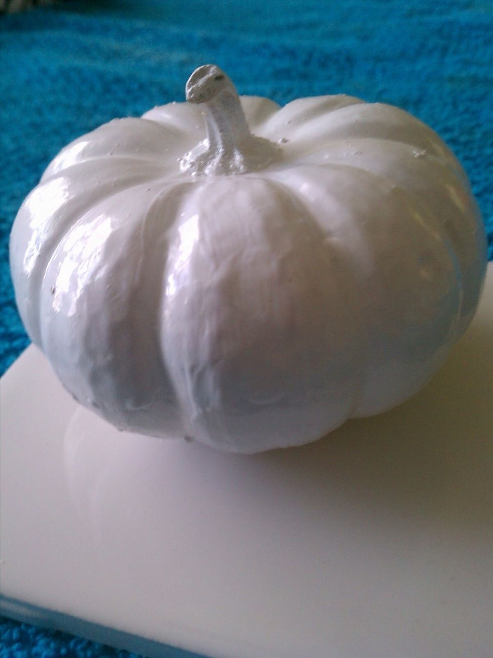 Start by painting your pumpkins and letting them dry completely.