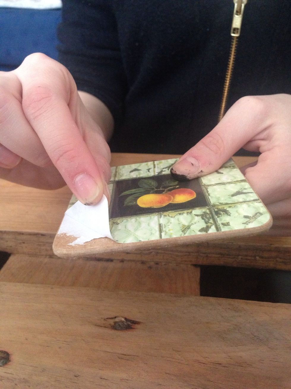 Start by peeling the glossy surface off the old mat.