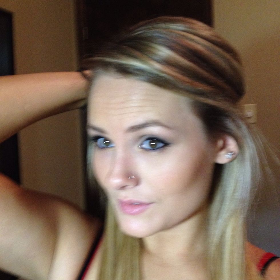 Start by pinning the front of your hair back. (If you like part of it down in the front or bangs leave this down. )