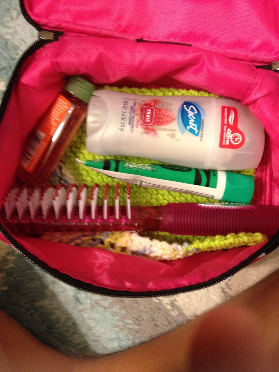 Start by placing deodorant toothpaste body wash towel and brush in your bag