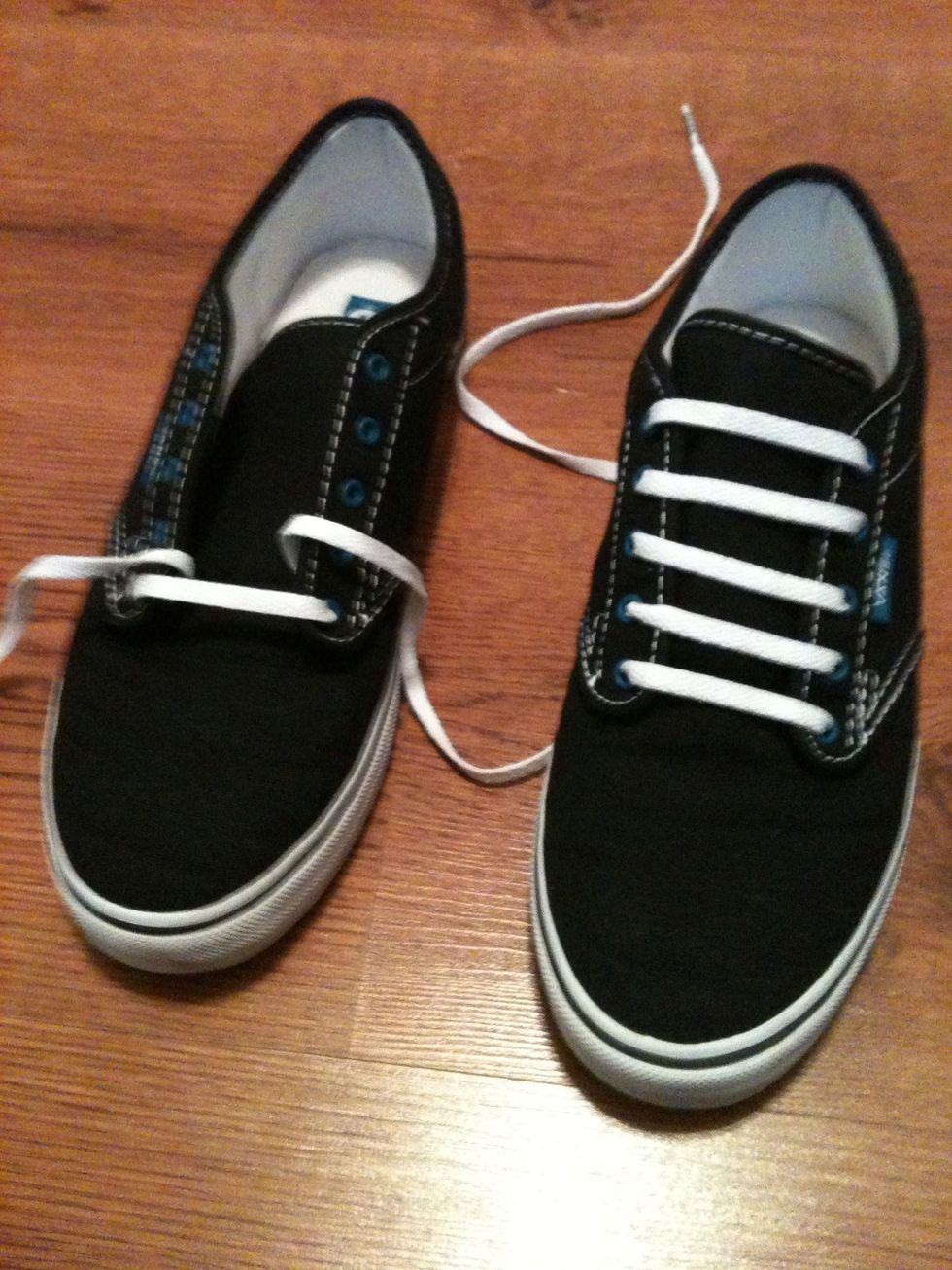 Start by putting one lace through the top of the bottom eye of the shoe